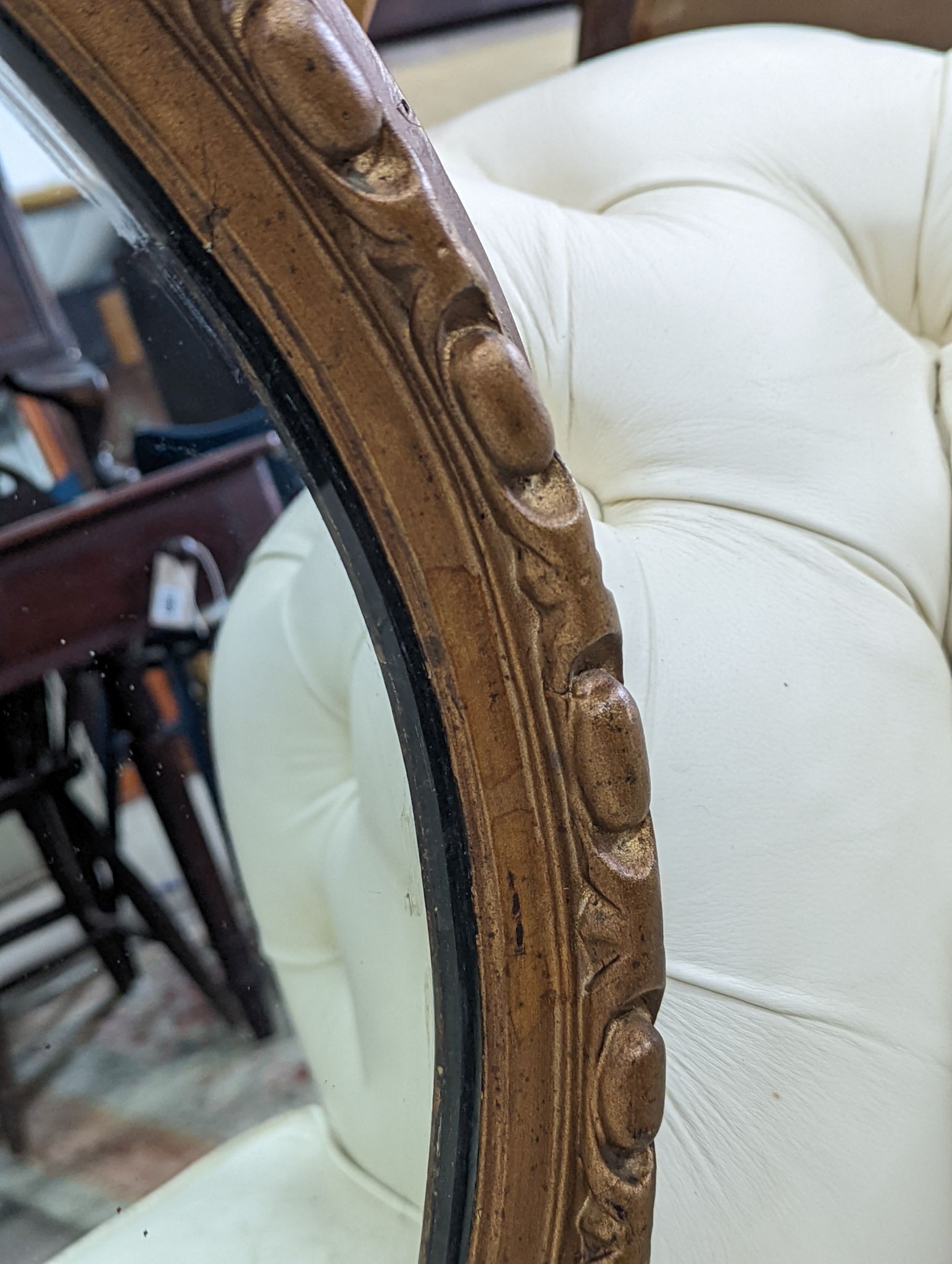 An early 20th century carved gilt oval wall mirror, width 110cm, height 80cm